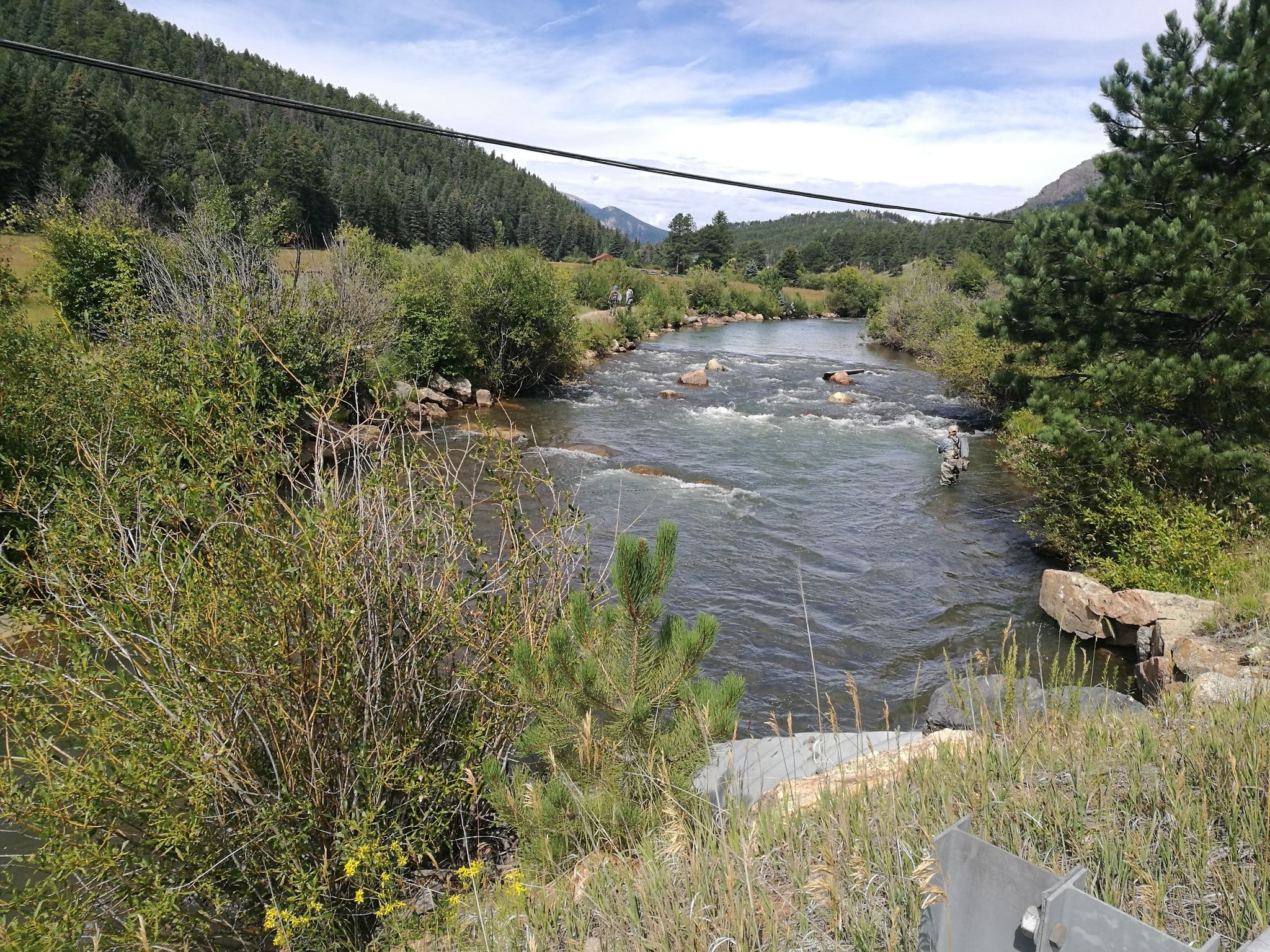 A wide river flows through a green valley surrounded by forested hills. - Colorado Trail: Redskin Mountain Loop