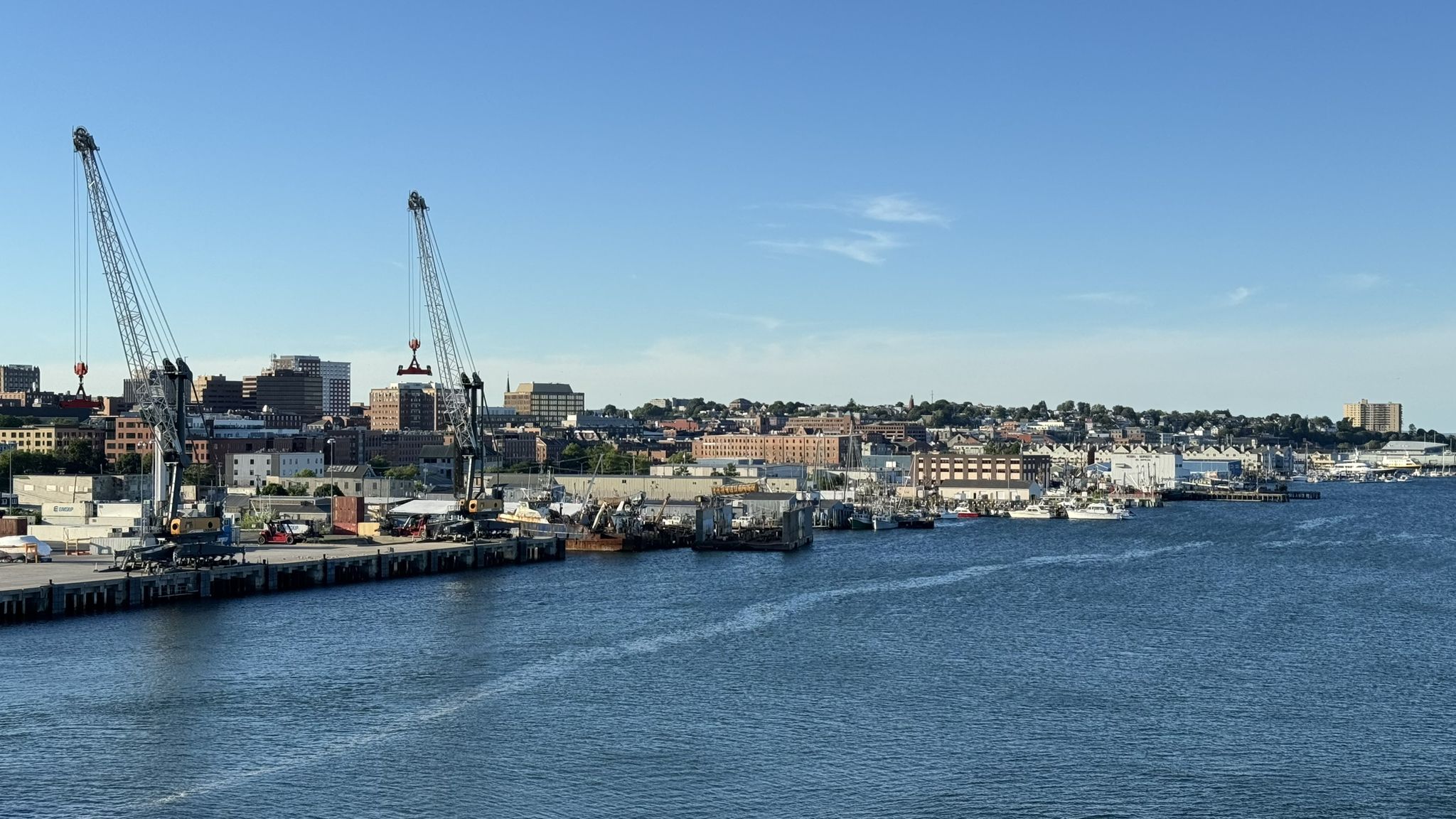 Bright city harbor with large cranes, docked boats, and buildings along the water. - Portland Head Light at Fort Williams Park – Casco Bay Bridge loop from Cape Elizabeth