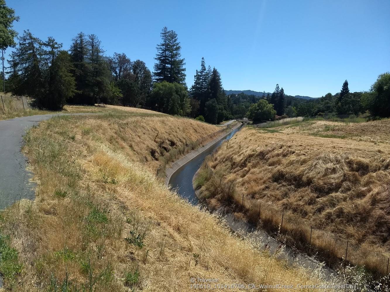 Paved path through dry grassy hills, alongside a narrow canal. - Iron Horse and Contra Costa Canal Trail Loop