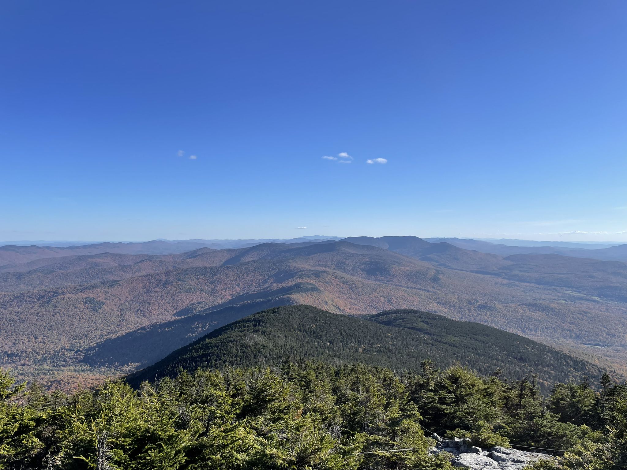 Clear day view of vast forested mountains under a bright blue sky. - Mount Abraham loop from Battell Trail Trailhead