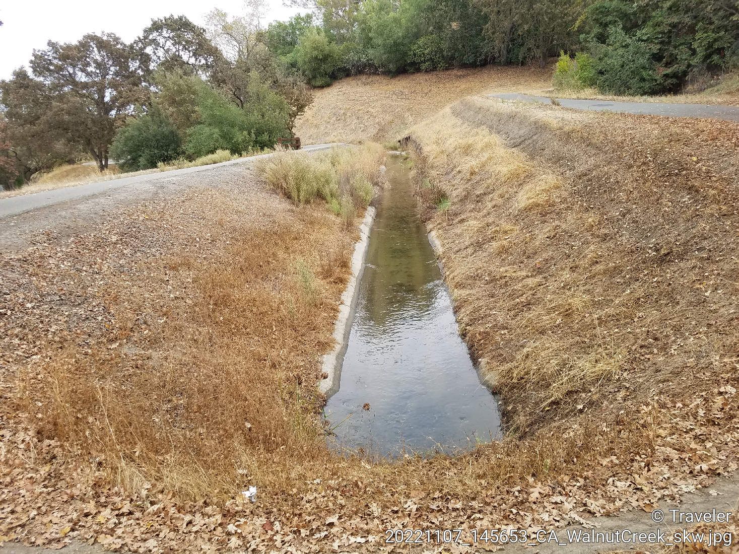 Concrete canal between dry grassy banks, with a paved road. - Pine Creek – San Miguel Park loop from Contra Costa Centre