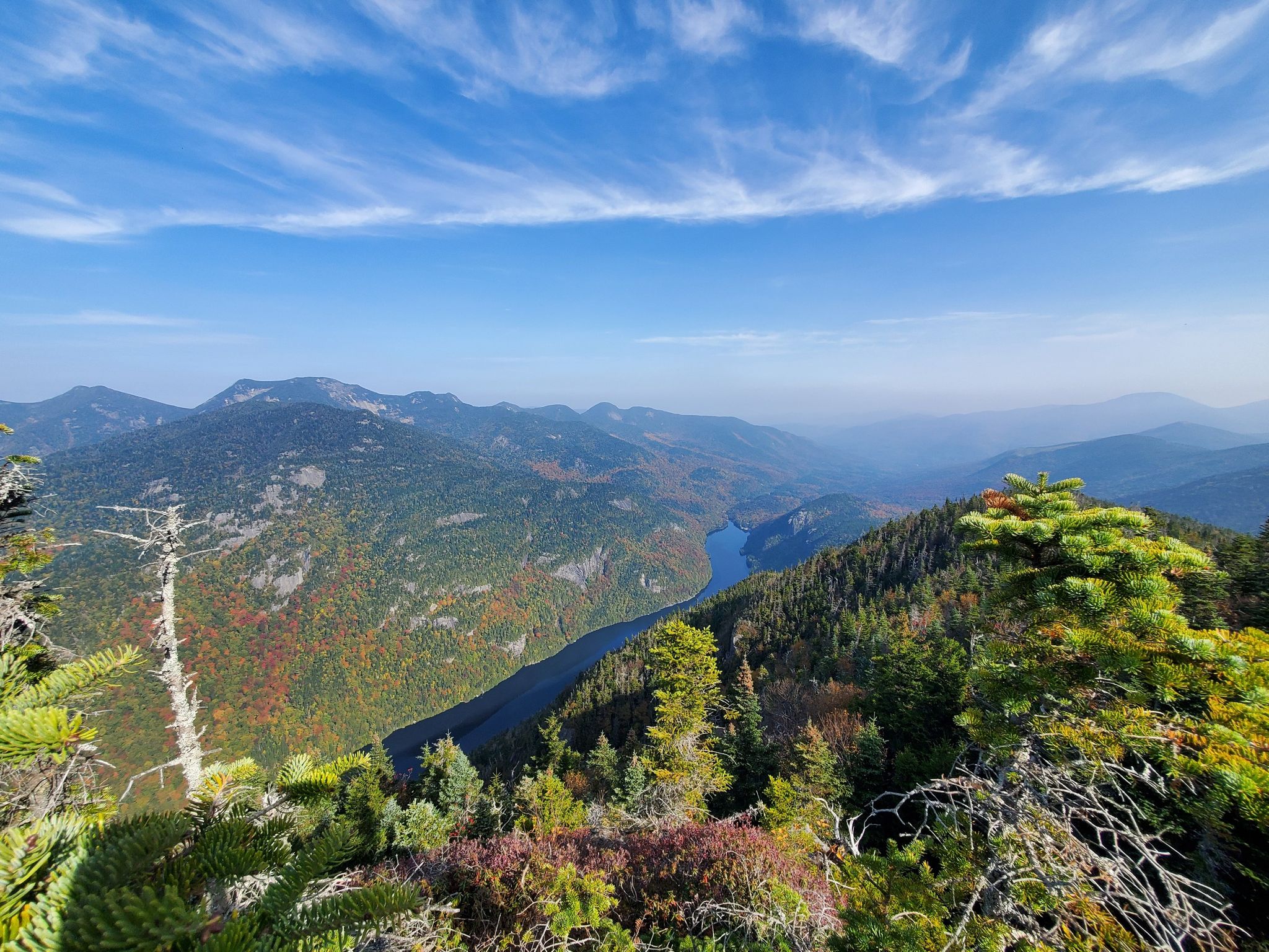 Panoramic view of mountains, a lake, and autumn foliage under a blue sky. - Mount Colvin and Blake Peak Trail