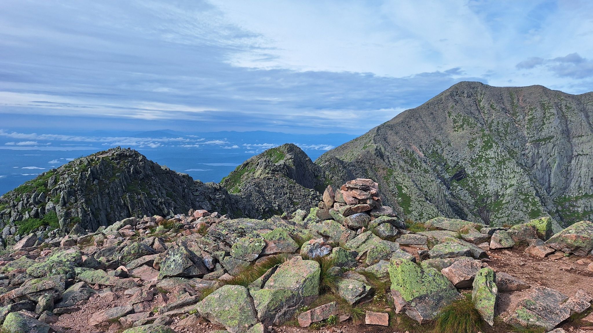 Rocky mountain ridge with a cairn under a cloudy sky. - Katahdin & Knife Edge loop