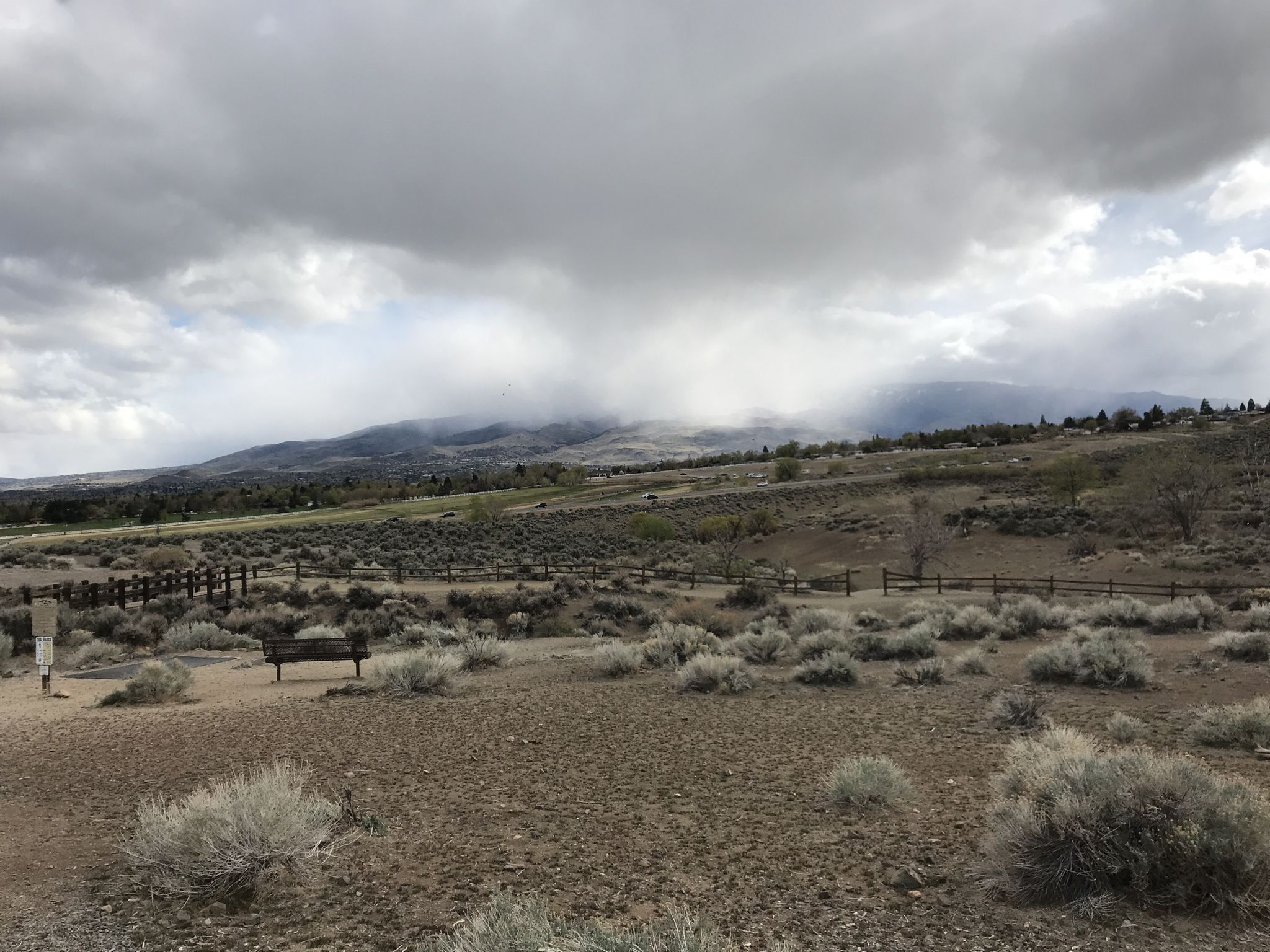 Overcast sky above a dry, bushy landscape with distant, cloud-covered mountains. - Evans Canyon and Keystone Canyon Loop