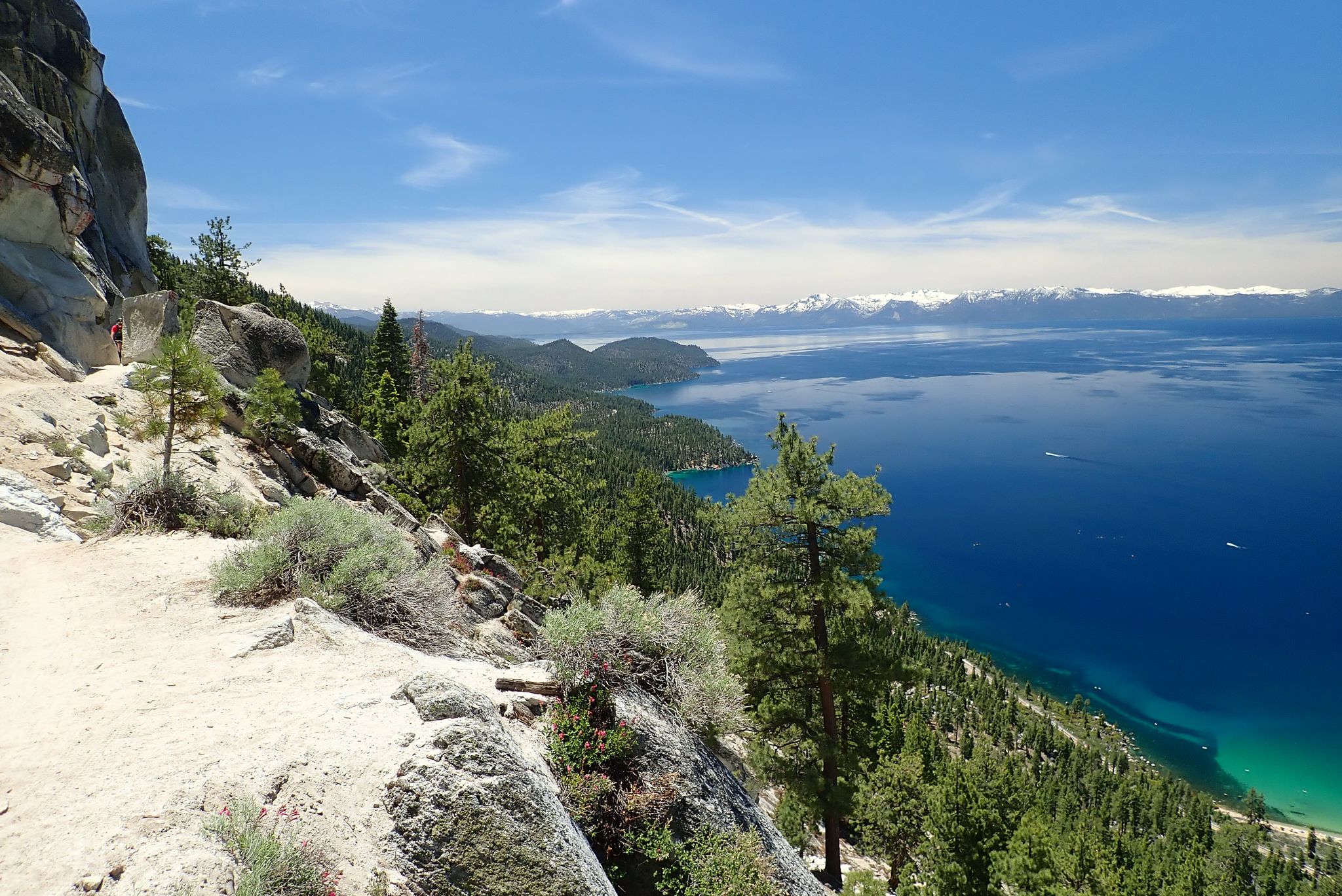 A rocky mountain trail overlooking a vast blue lake and distant snowy peaks. - Marlette Lake – Marlette Flume Trail loop from Glenbrook
