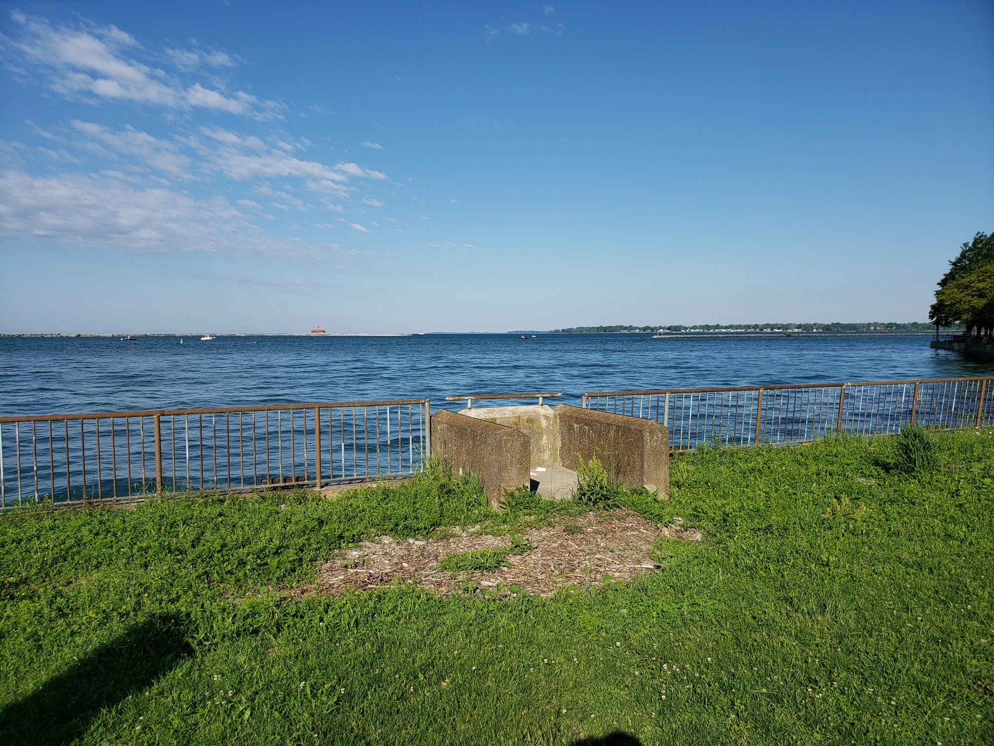 Bright sunny day over a large blue water body with green grass. - Erie Canalway Trail: Buffalo Parks and Waterfront Loop