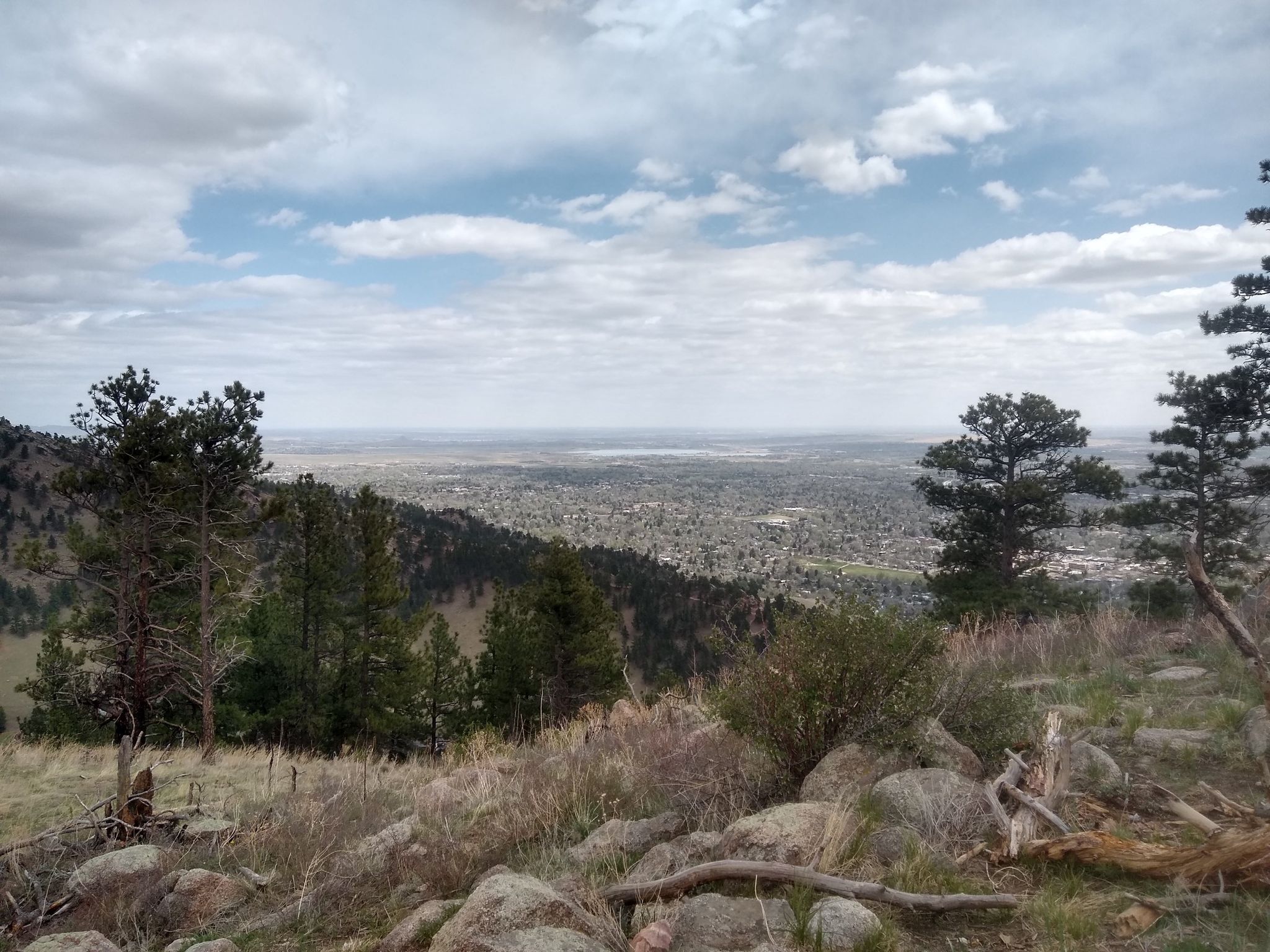 Panoramic view of a vast valley with scattered buildings under cloudy sky. - Red Rocks and Anemone Loop