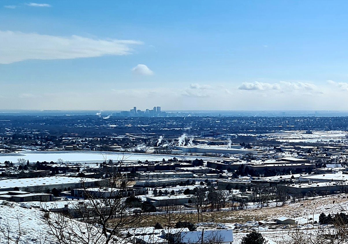 A snowy urban landscape with distant city skyline under a bright blue sky. - Mesa Top and Cottonwood Canyon Loop