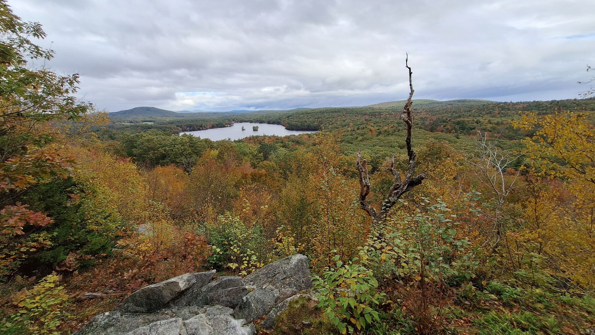 Overcast view from a rocky outcrop overlooking a lake and autumn forest. - Mount Hunger Views