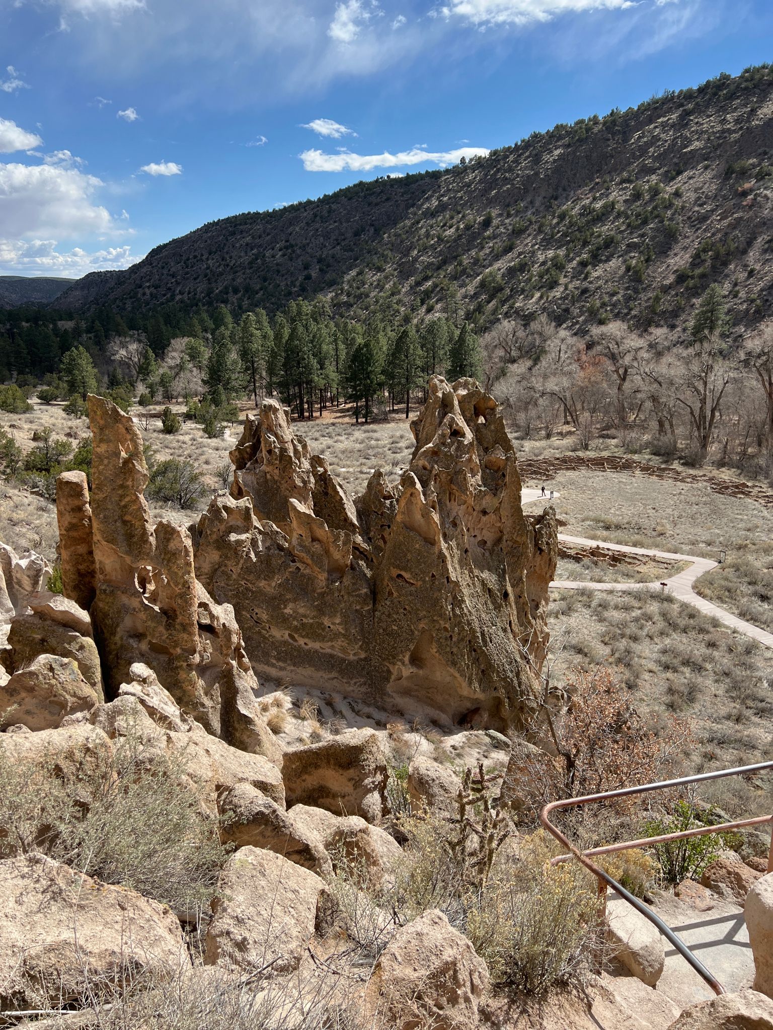 Unique rock formations in a valley with distant mountains under a partly cloudy sky. - Frey Trail and Pueblo Loop Trail