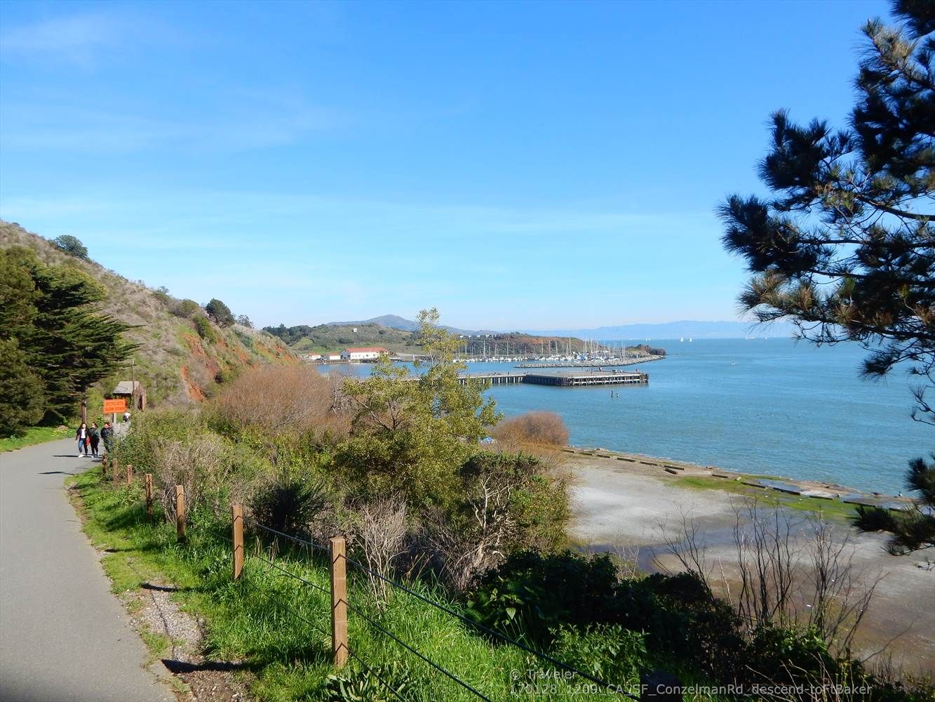 People walk on a paved path overlooking a marina on a sunny day. - Bay Area Ridge Trail: Golden Gate Bridge