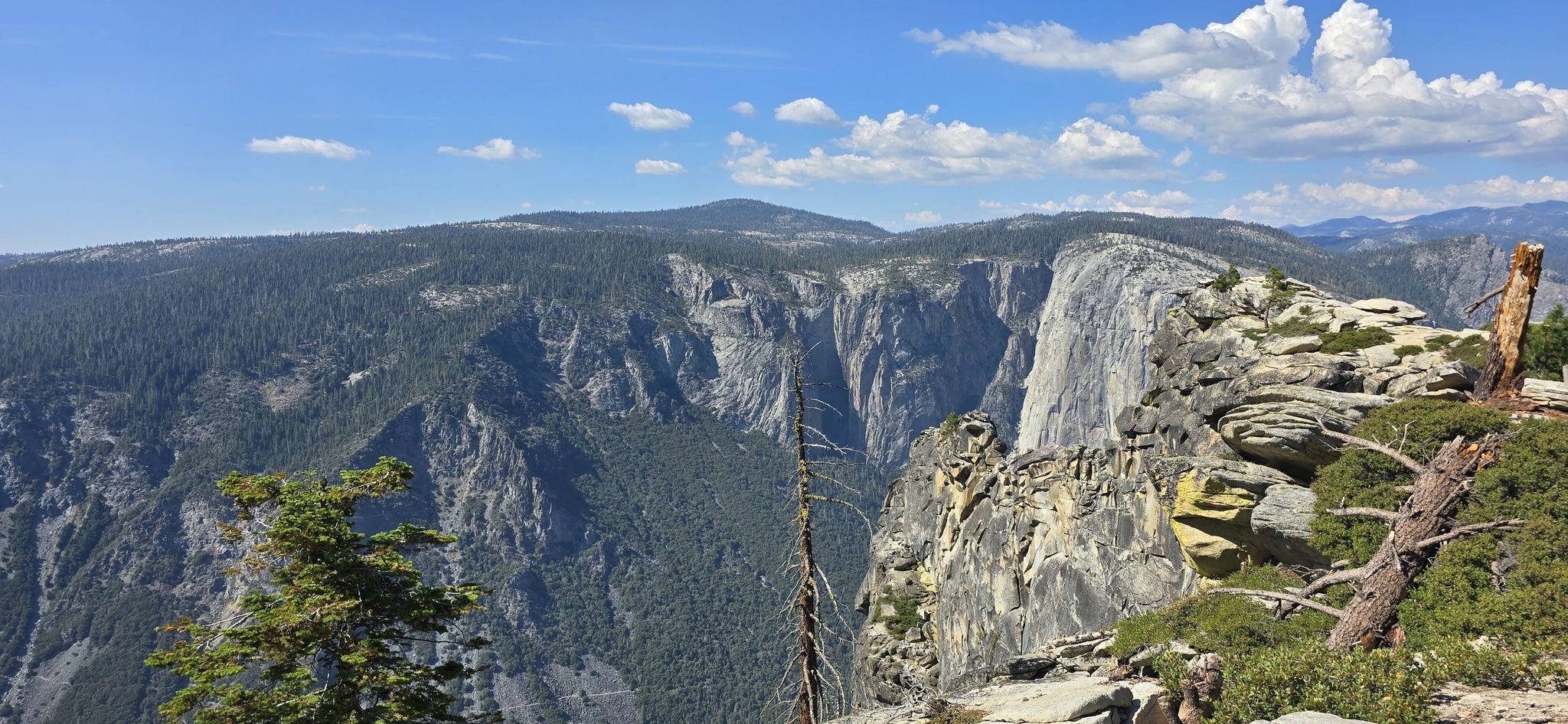 Panoramic view of a mountain valley with steep granite cliffs under a blue sky. - Dewey, Crocker, and Stanford Point via the Pohono Trail
