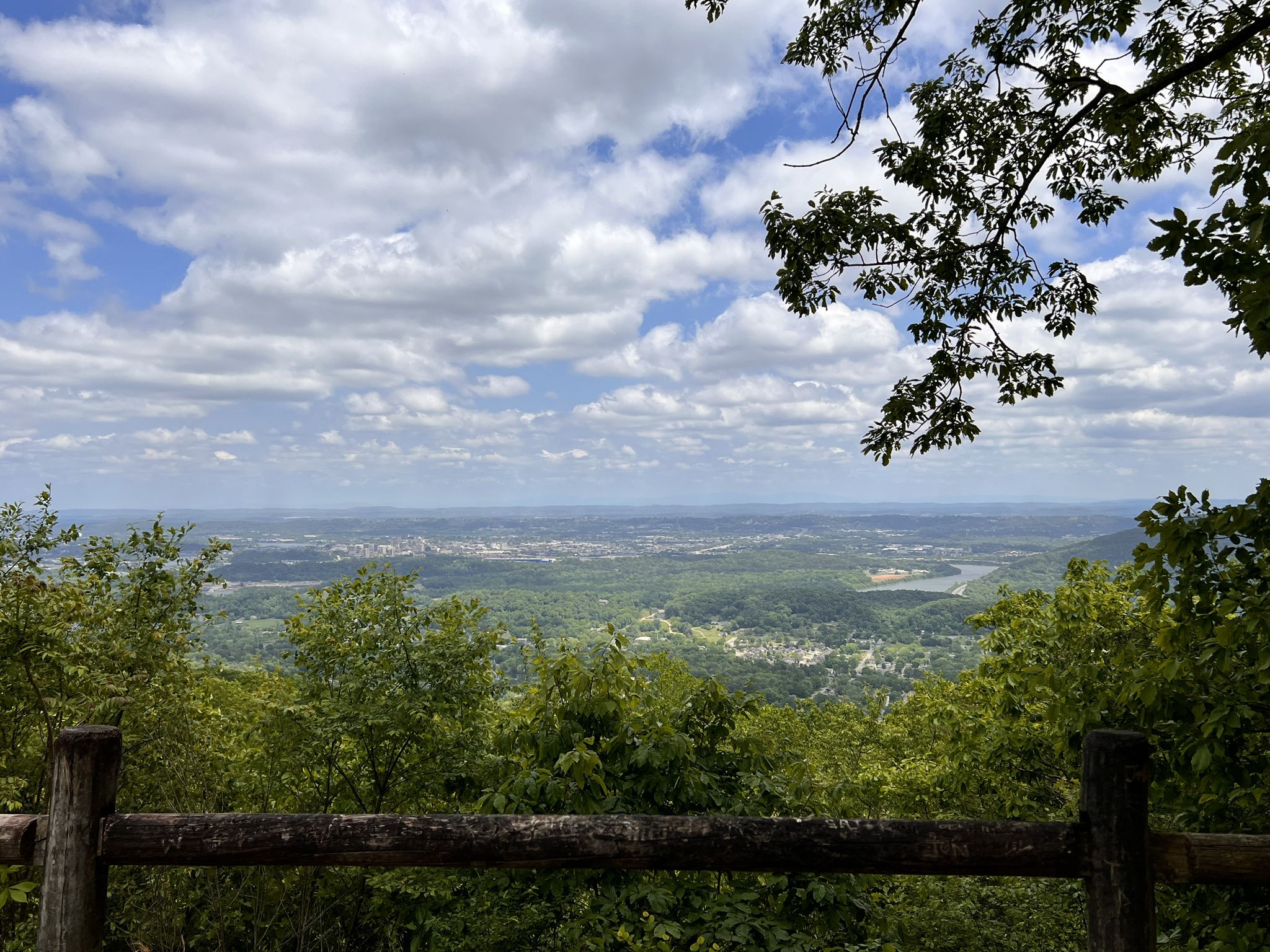 Expansive mountain overlook with a distant city, river, and cloudy sky. - Raccoon Mountain Reservoir trail loop