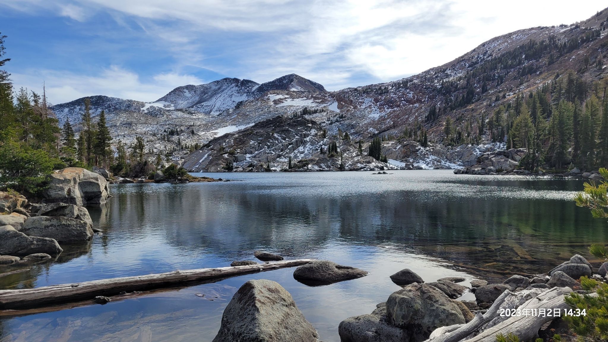 Calm lake reflecting snow-dusted mountains and a blue sky. - Eagle Falls Trailhead to Middle Velma, Dicks, and Susie Lake