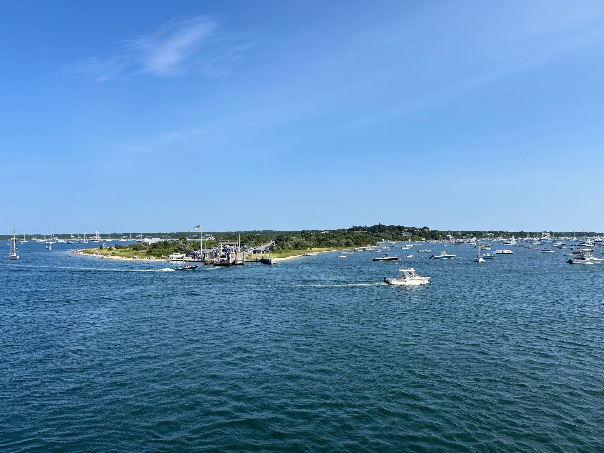 Wide blue water with many boats and a distant green island. - Mill Hill – Sampson Hill loop from Katama Airpark