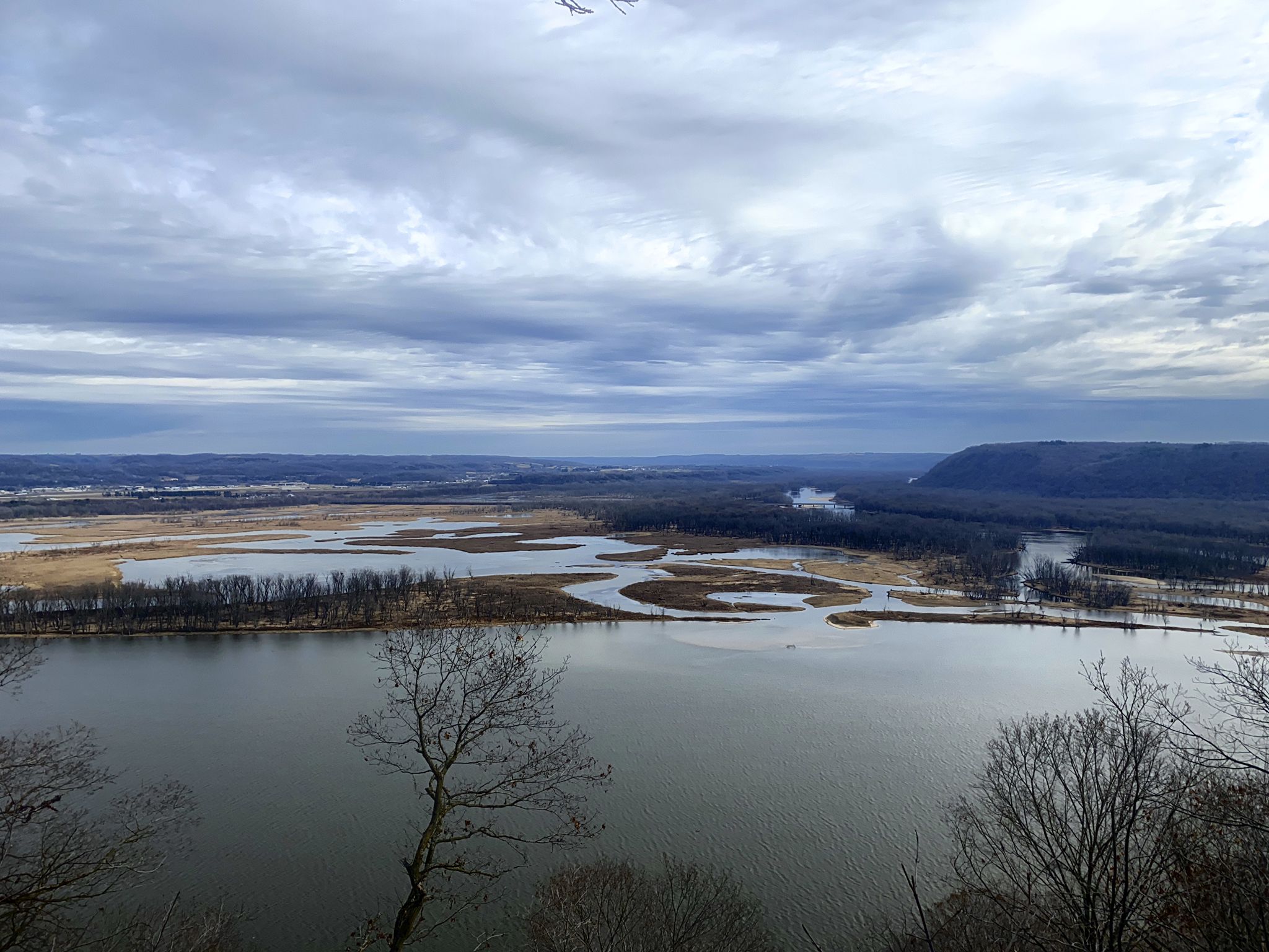 Wide river with islands and wetlands under an overcast sky. - Pikes Peak State Park loop