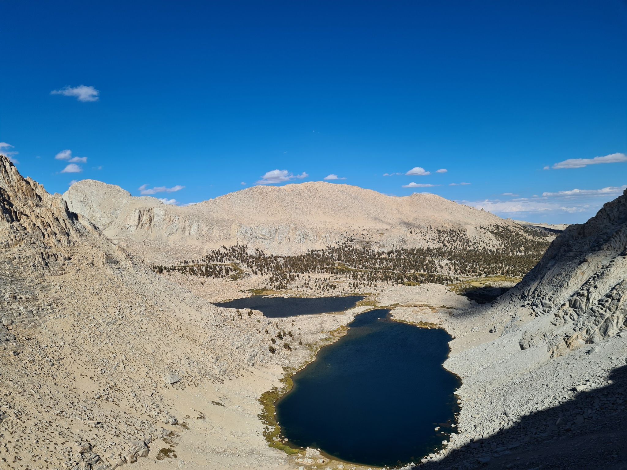 Two dark lakes in a rocky mountain valley under a clear blue sky. - Cottonwood Lakes and Army Pass Loop