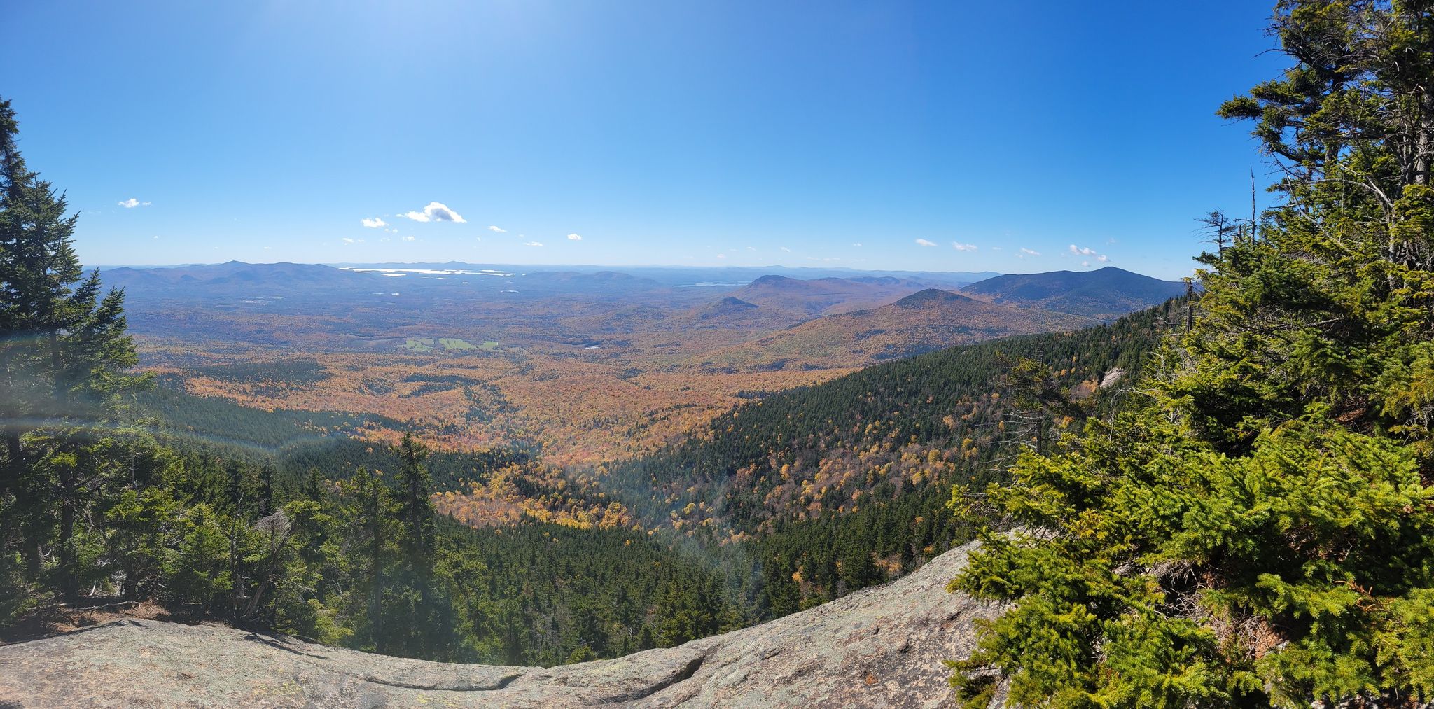 Panoramic view of a vast valley with autumn trees under a bright blue sky. - Mount Whiteface and Passaconaway Loop