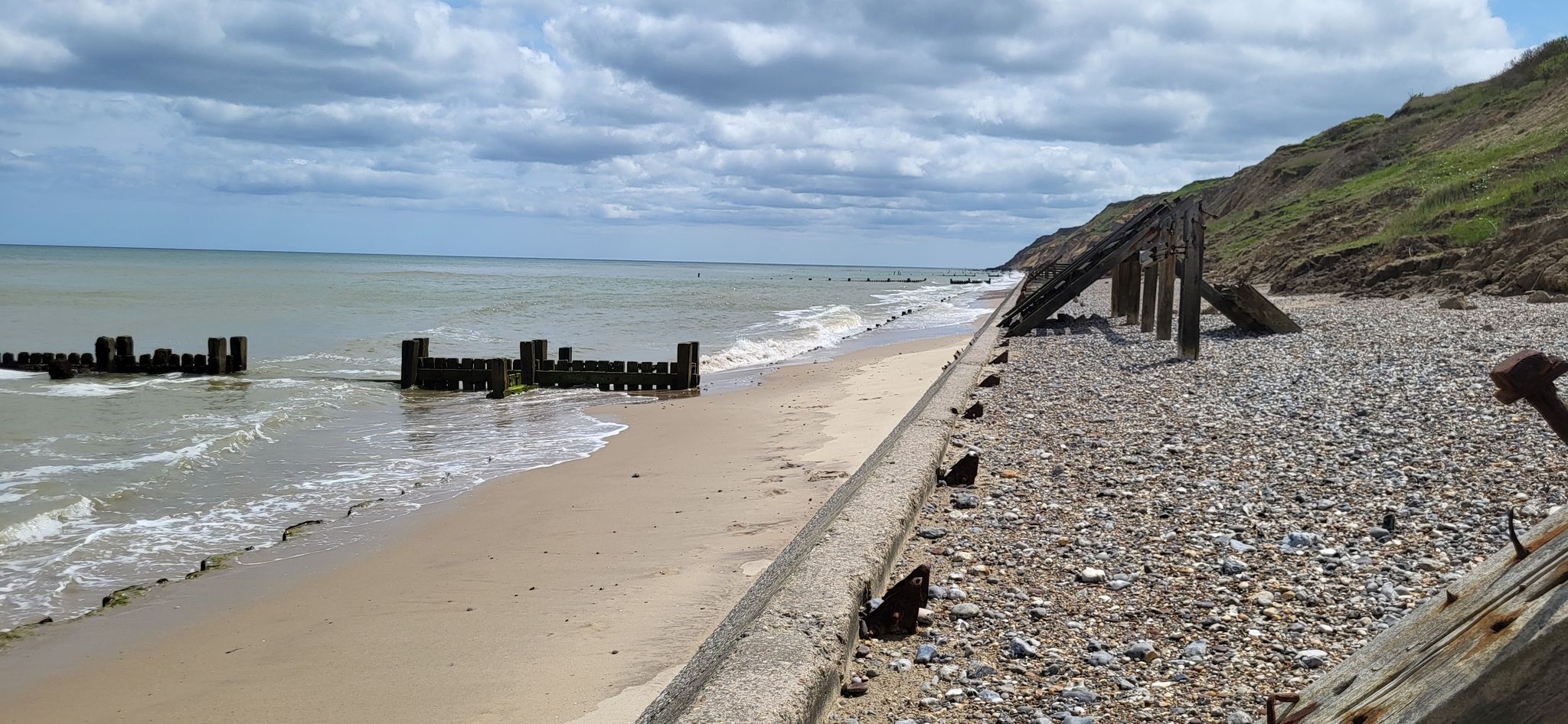 walking on the shingle behind the sea defences