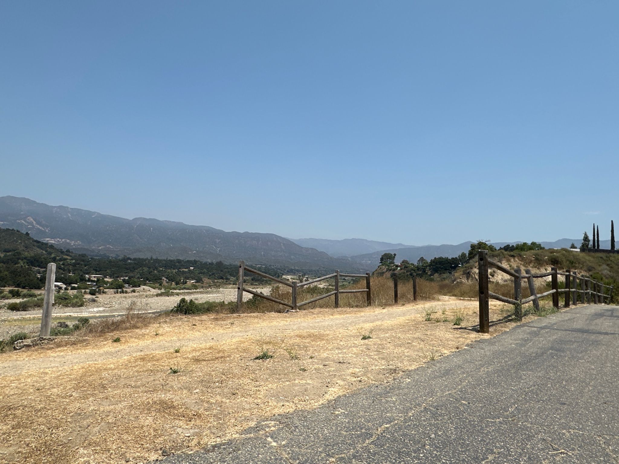 Dry grassy hill overlooking a valley and distant mountains under clear sky. - Ojai-Ventura Bike Path – San Antonio Creek Bridge loop from Big Rock Preserve