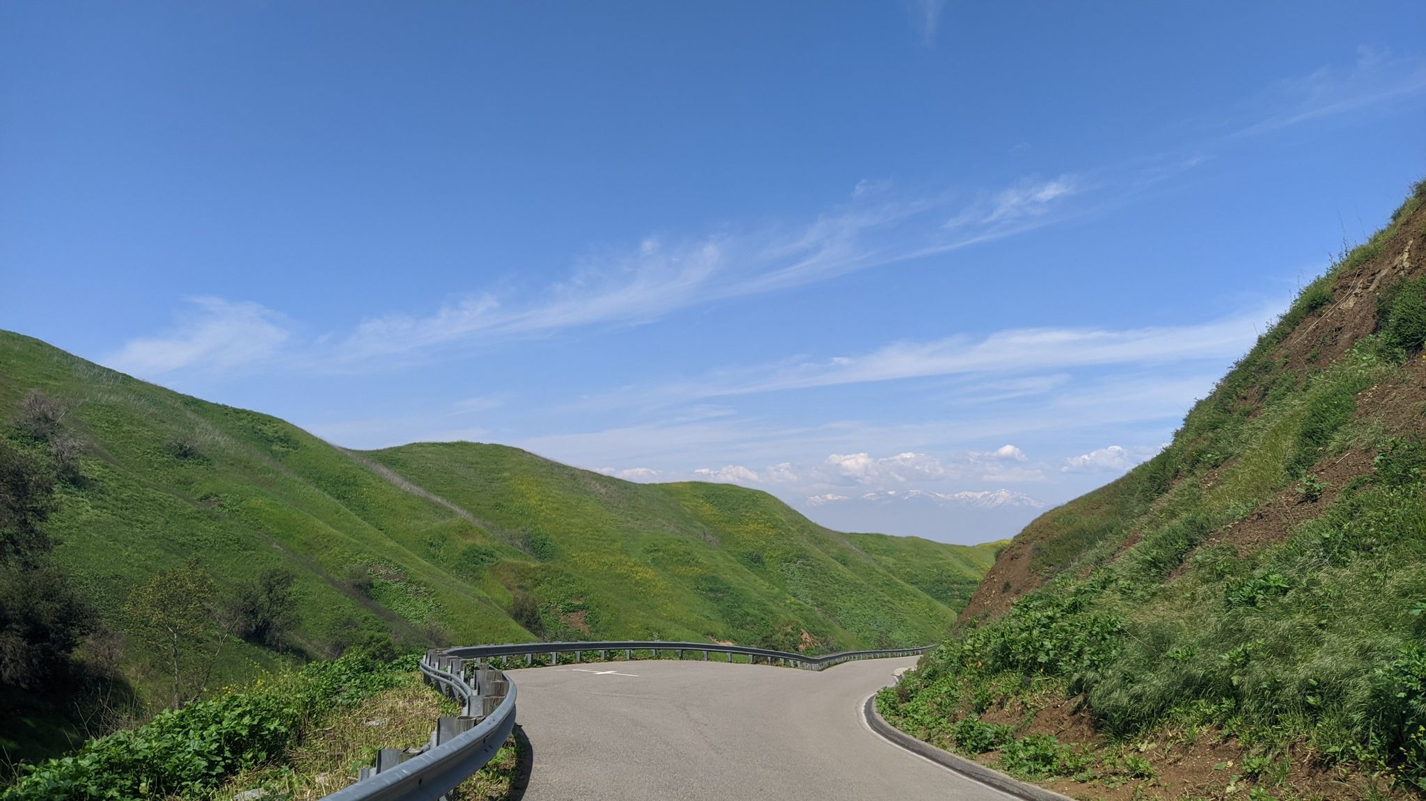 Winding road through lush green hills under a bright blue sky. - Bane Ridge, Sidewinder, and Aliso Canyon Loop