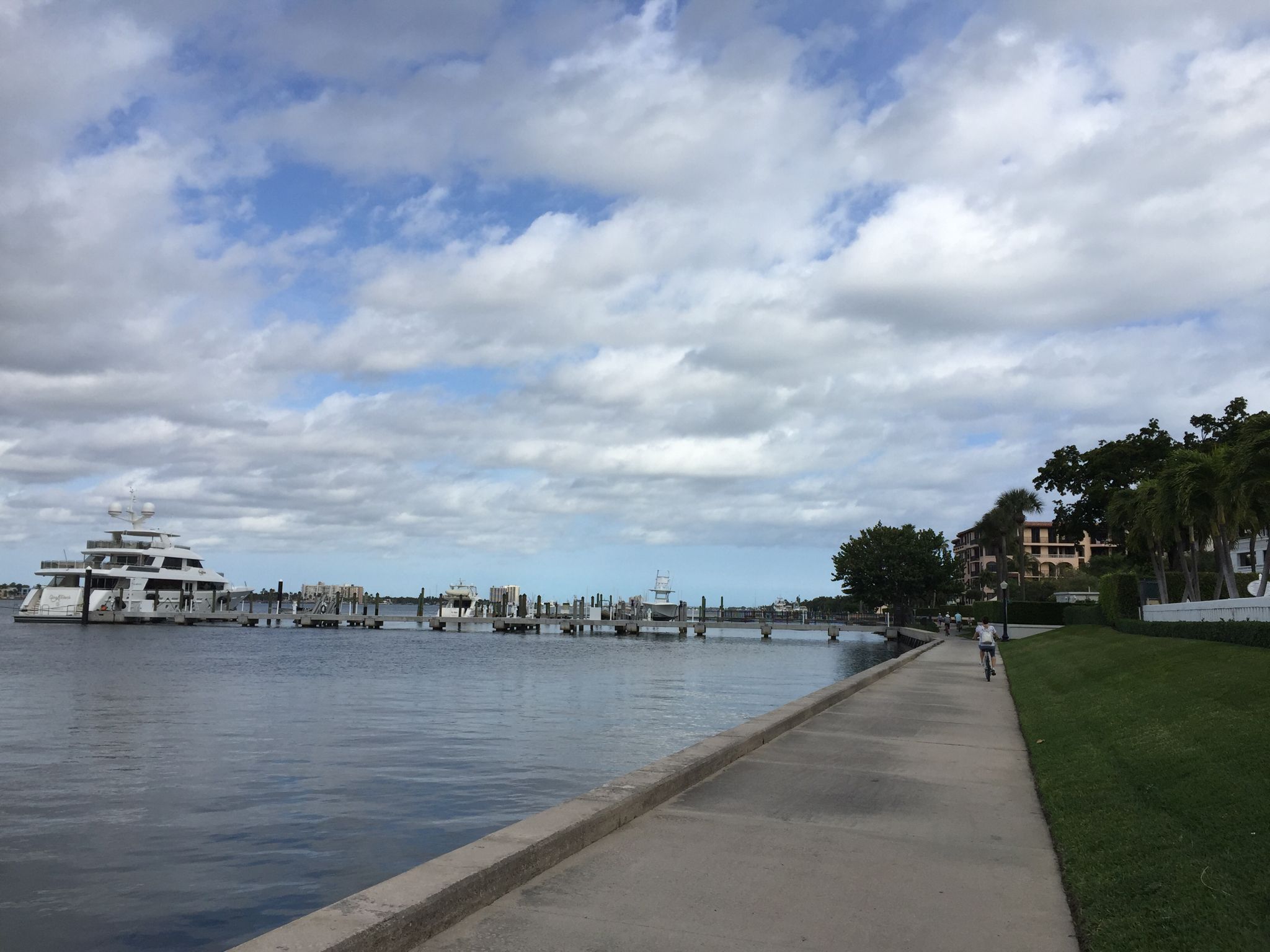 Waterfront promenade with a large yacht docked and a person cycling. - Lake Trail – Lake Trail loop from West Palm Beach
