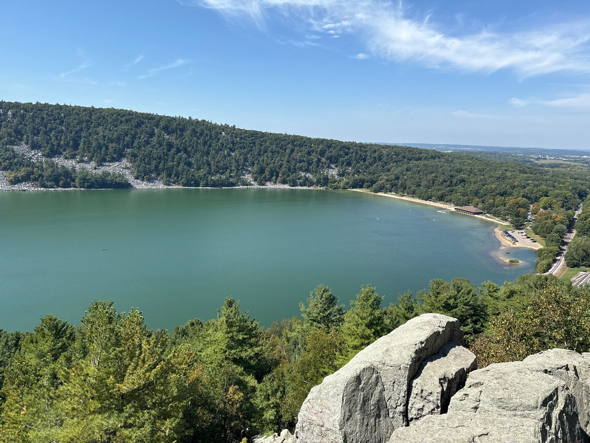 Sunny view from a rocky cliff of a green-blue lake and lush forest. - Elephant Rock & Upland Trail Loop