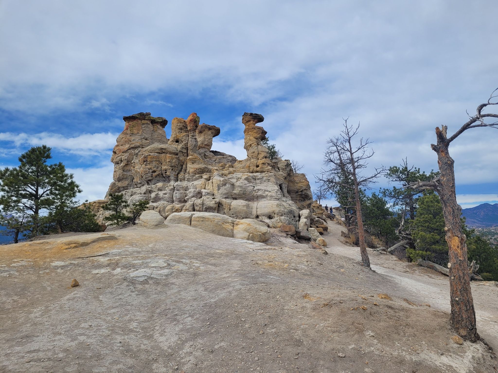 Distinctive rock formations on a hill under a partly cloudy sky. - Pulpit Rock loop from University of Colorado Colorado Springs