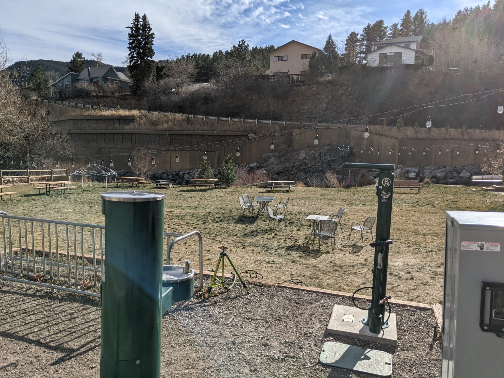 Outdoor recreation area with picnic tables, equipment, and distant houses on a sunny day. - Jamestown Park – Jamestown Mercantile Café loop from Jamestown