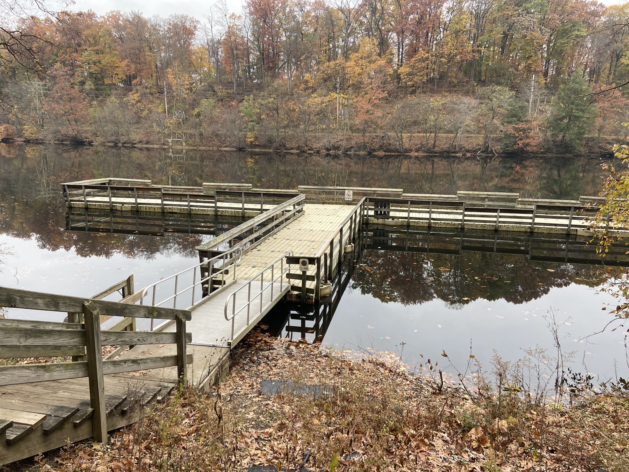 Wooden dock extending into a calm lake, surrounded by autumn trees. - Highbridge and Gorge Trail Loop