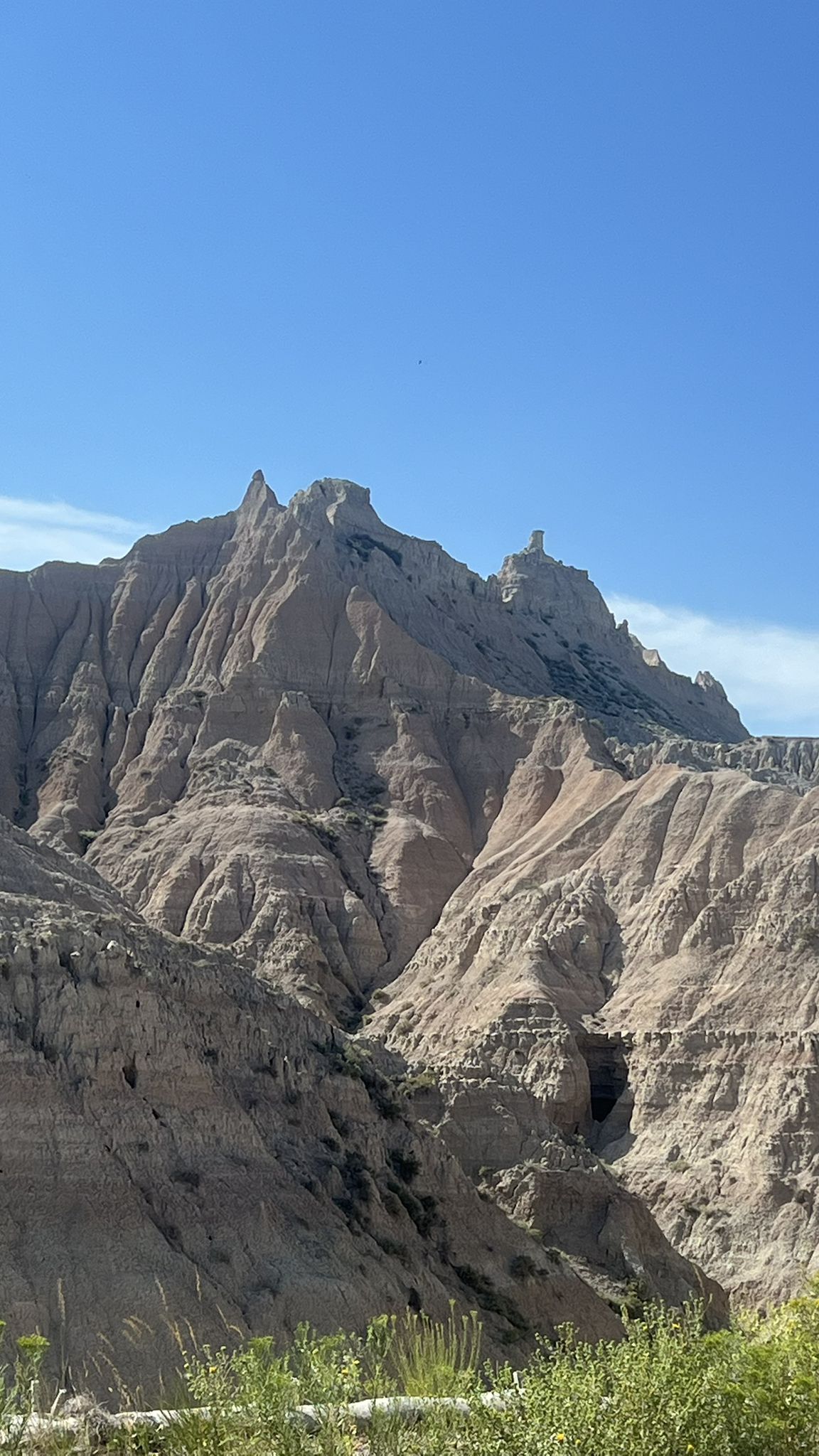 Majestic, eroded rock formations under a bright blue sky on a sunny day. - Scenic loop