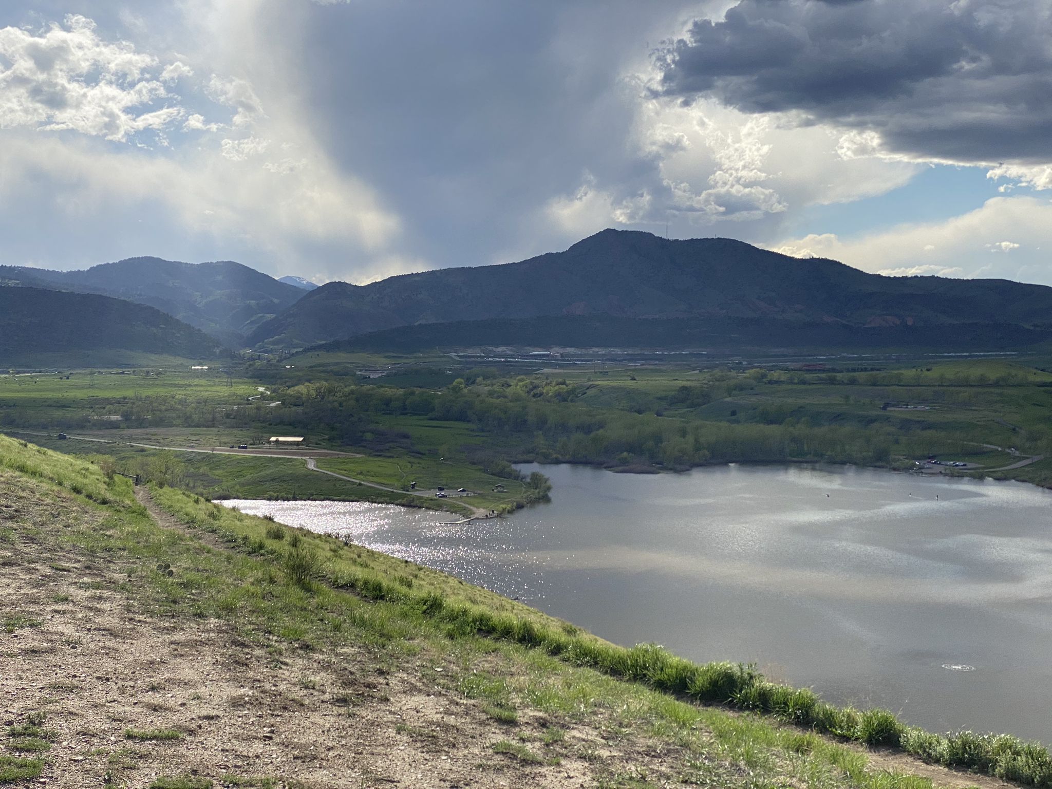 Overcast sky above a large lake, green hills, and distant mountains. - Bridge over South Platte River – Mount Carbon Loop loop from Oxford - City of Sheridan
