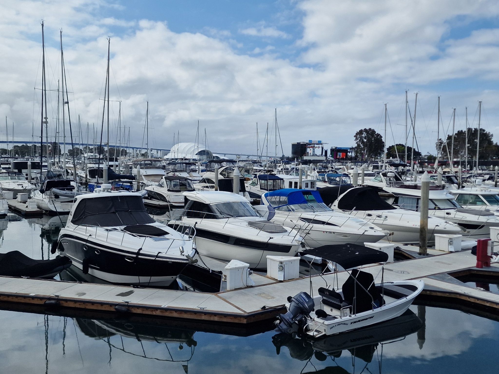 Many boats docked in a busy marina under a partly cloudy sky. - Gaslamp Quarter – Gate to historic downtown loop from San Diego