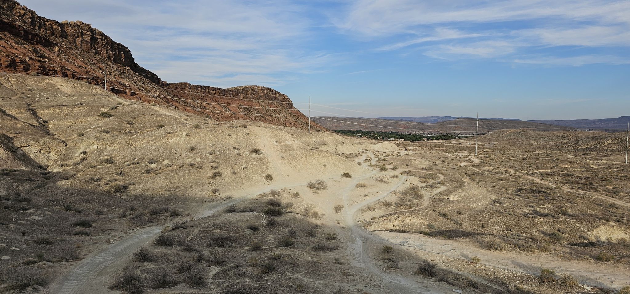 Arid desert landscape with dirt roads winding through rocky hills under a bright sky. - Bloomington Park – Bearclaw Poppy Trail loop from Hidden Valley