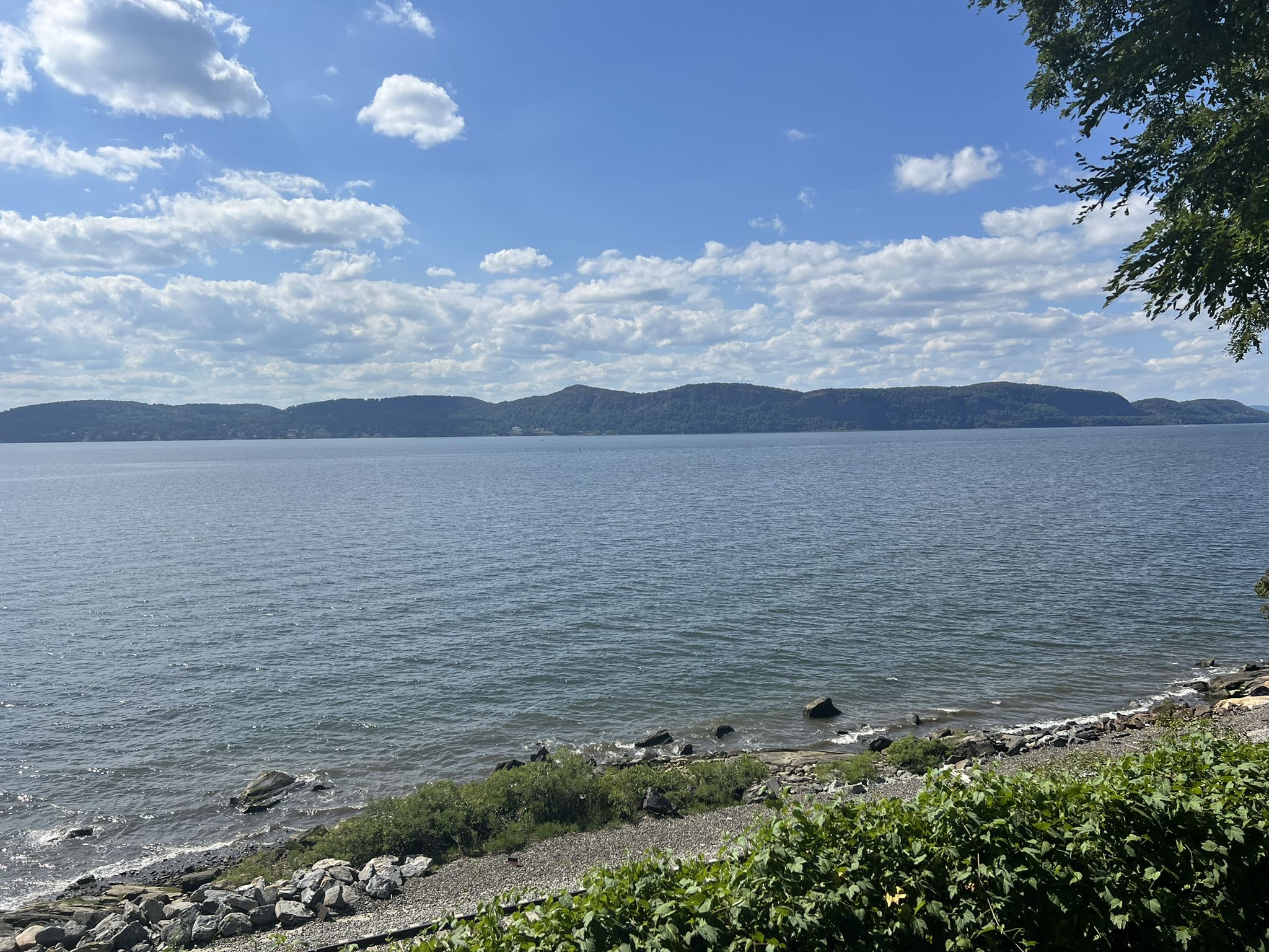 Wide body of water with distant hills under a partly cloudy sky. - Rockwood Hall Trail