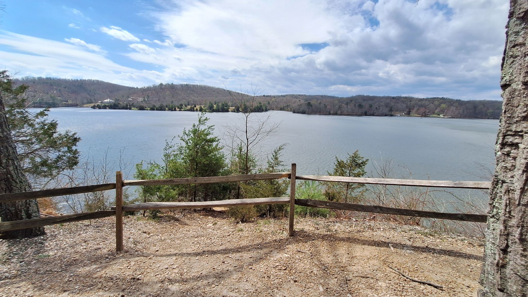 Scenic lake view from a hill, framed by a wooden fence. - Claytor Lake Overlook loop from Claytor Lake State Park