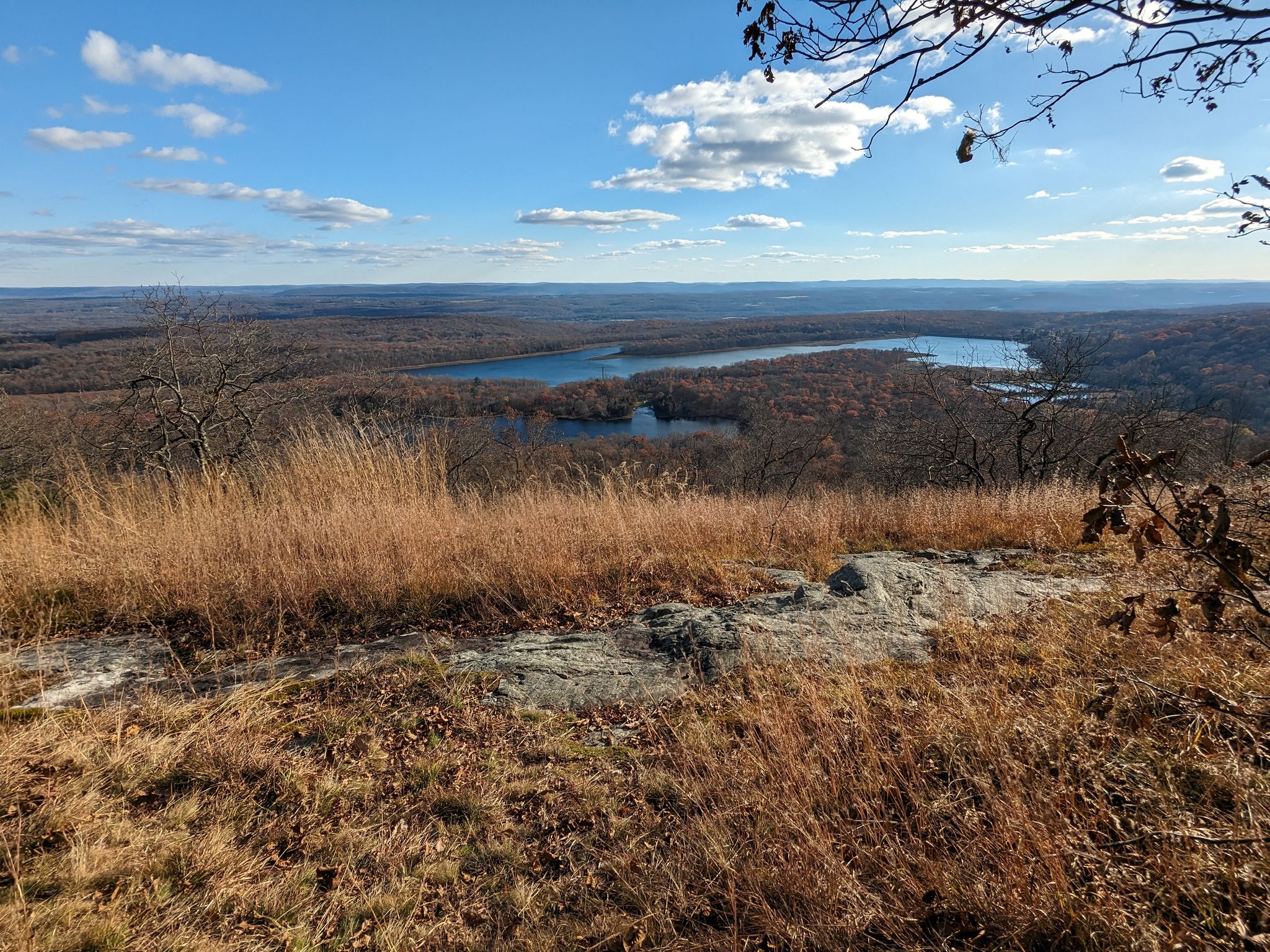 Panoramic view of a lake surrounded by autumn forest under a bright sky. - Raccoon Ridge via Coppermine, Appalachian, and Kaiser Trails Loop