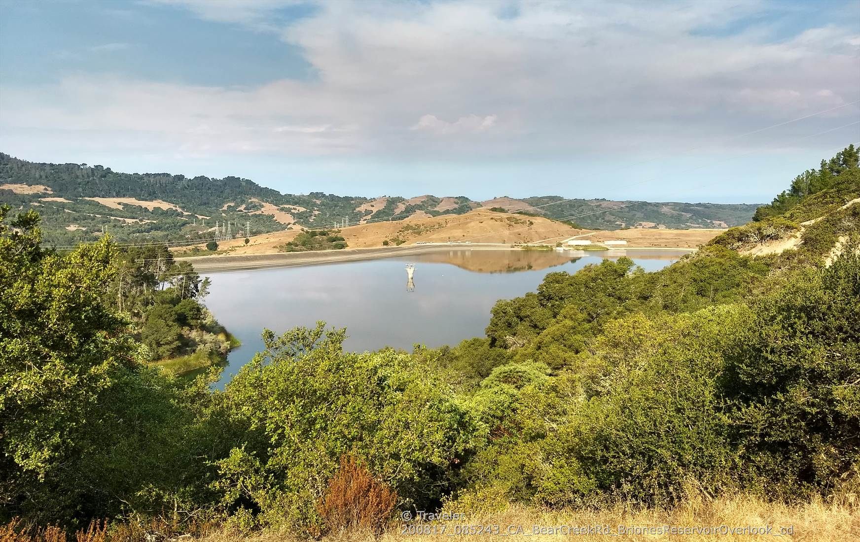 Lake surrounded by green and brown hills under a partly cloudy sky. - Briones Reservoir and San Pablo Reservoir loop