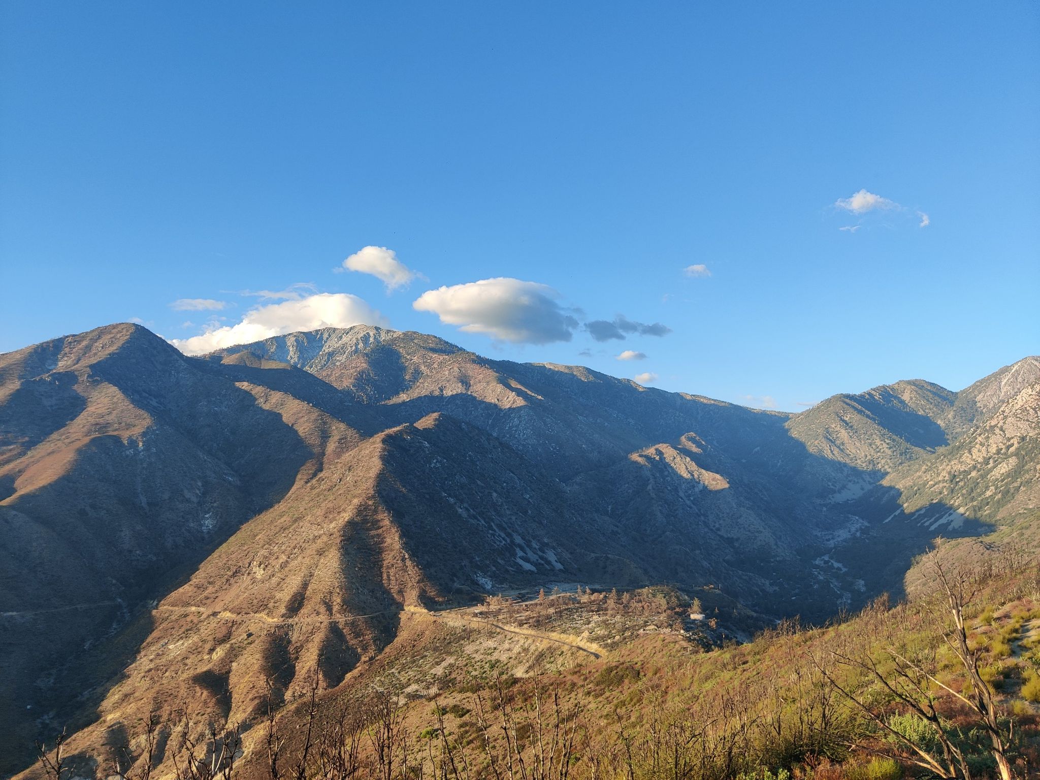 Rugged mountain range under a bright blue sky with scattered clouds. - San Dimas Canyon to Sunset Peak Radio Towers