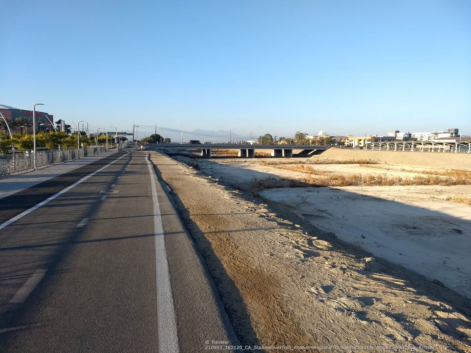 Paved path next to a dry, sandy area under a clear sky. - Angel Stadium loop from Disneyland