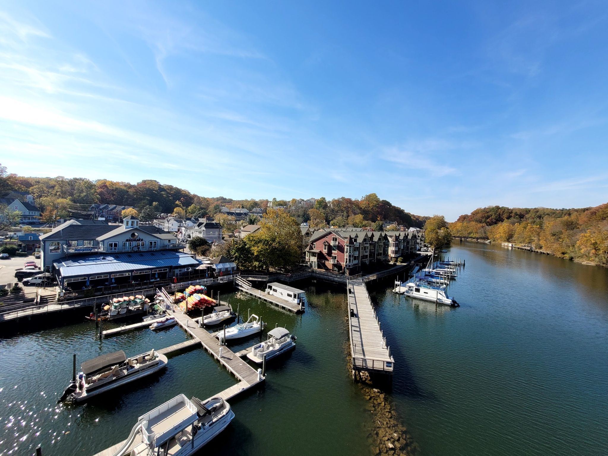Aerial view of a sunny marina with boats docked along a river. - Burke Lake – Burke Lake Trail loop from Woodbridge