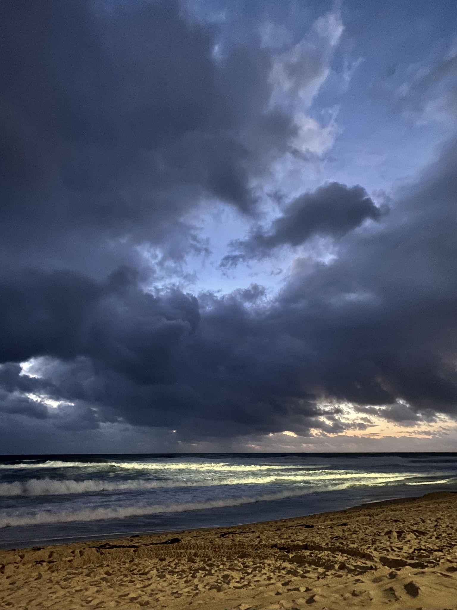 Dark, dramatic clouds over ocean waves at dusk or pre-storm. - SDSU Beach – Mission Bay loop from Pacific Beach