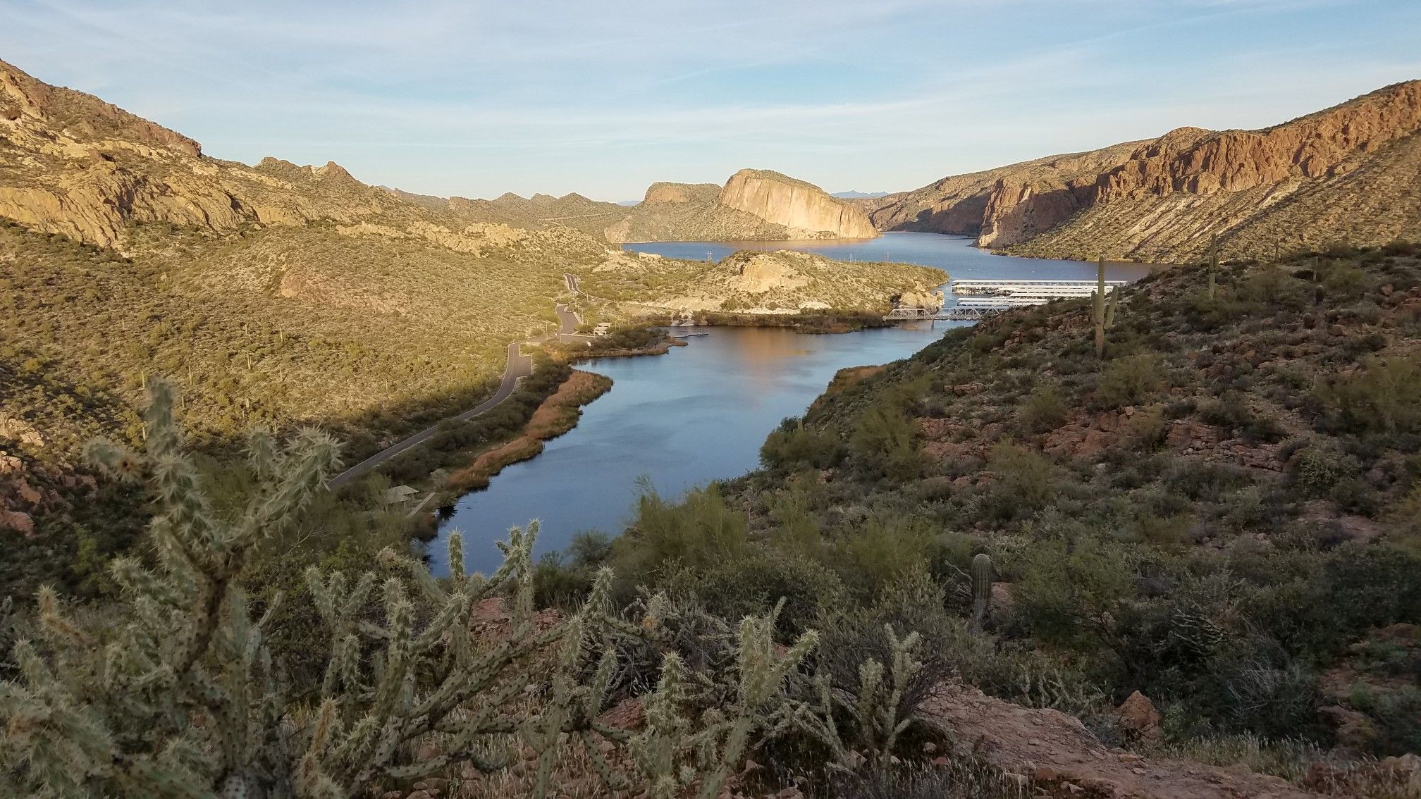 River flowing through a desert canyon with rocky hills under a bright sky. - Battleship Mountain and Boulder Canyon Trail Loop