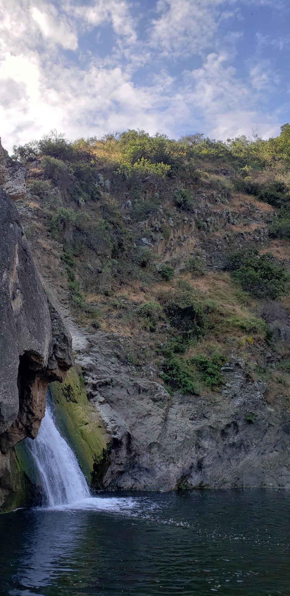 Waterfall cascading into a dark pool at the base of a steep, rocky hillside. - Paradise Falls via Fort Trail and Wildwood Canyon