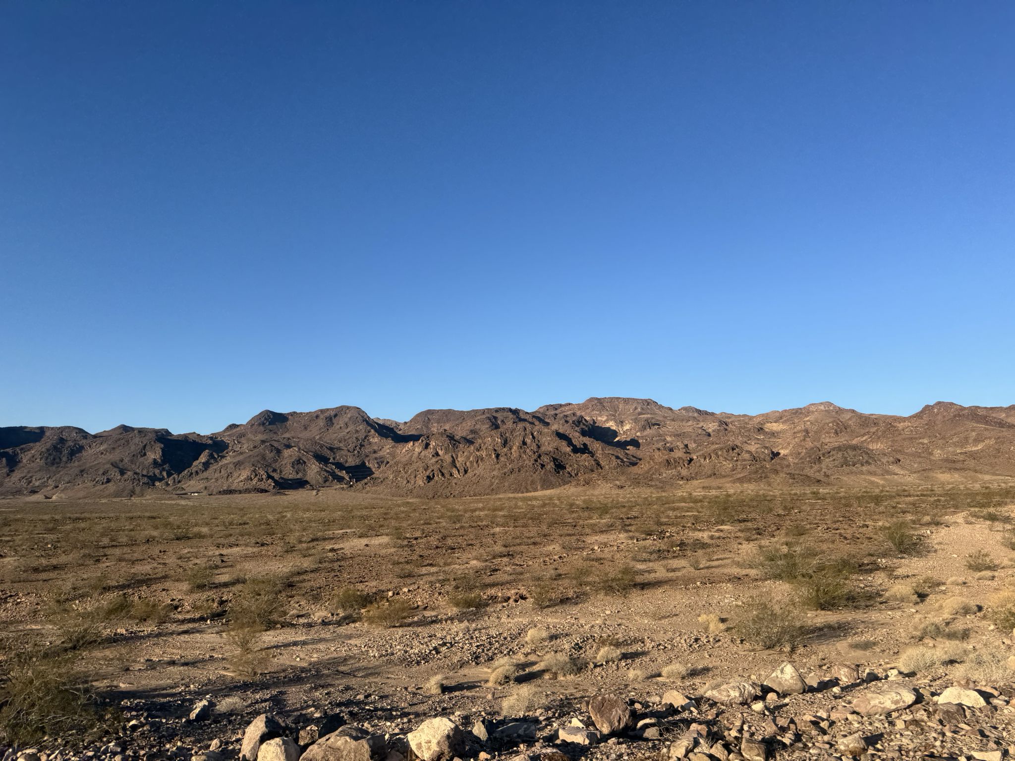 Vast desert landscape with rugged mountains under a clear blue sky. - Shaded picnic table loop from Historic Railroad Trailhead Parking Lot