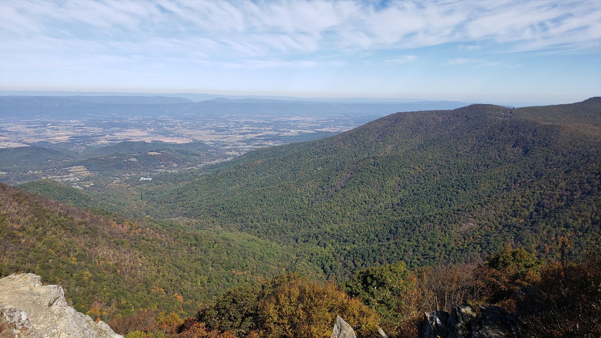 Autumn mountain landscape with changing foliage under a partly cloudy sky. - Upper Hawksbill Trail