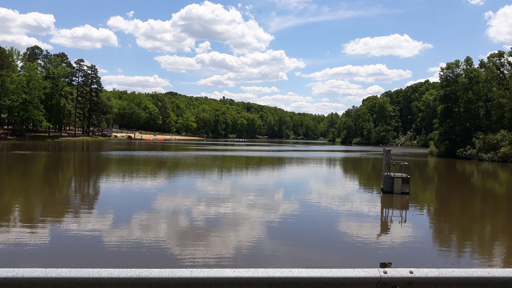 Calm lake reflecting a bright sky, surrounded by dense green forest. - High Bridge – High Bridge Trail loop from Twin Lakes State Park