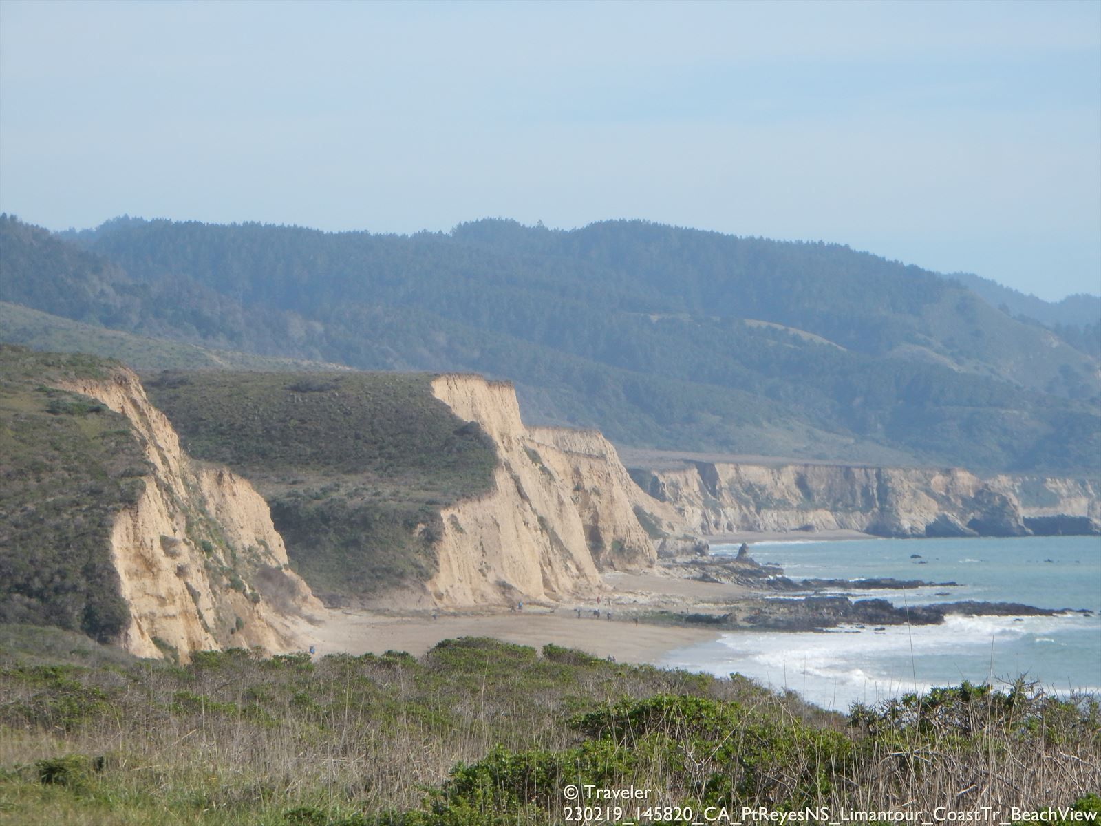 Rugged coastal cliffs and a beach next to the ocean, with distant mountains. - Coast Camp and Beach – Santa Maria Beach access loop from Muddy Hollow Trailhead parking lot