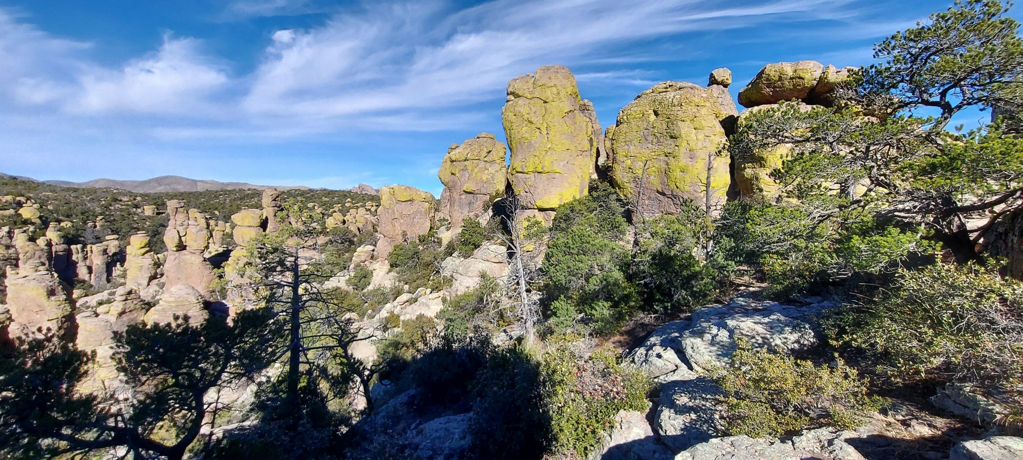 Tall, weathered rock formations under a bright blue sky with scattered clouds. - Balanced Rock in Echo Canyon – Echo Park loop from Chiricahua National Monument