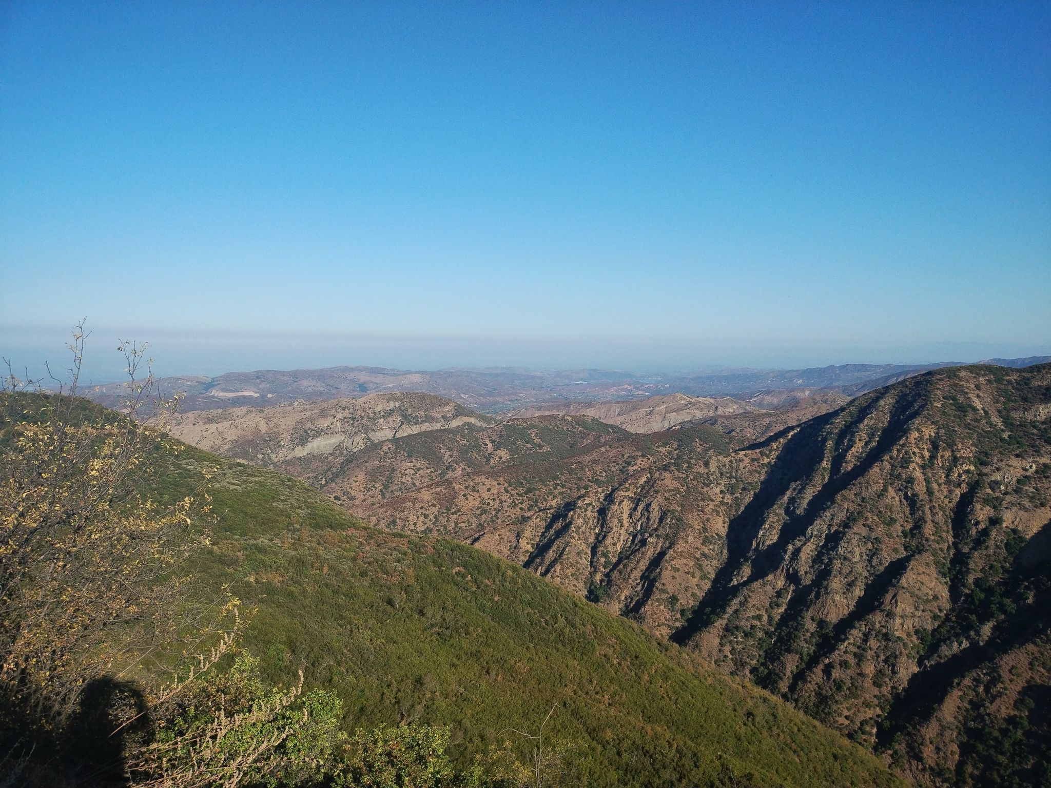 Expansive view of steep, rugged mountains and valleys under a clear blue sky. - Santiago Peak loop from Modjeska Canyon and Tucker Wildlife Sanctuary